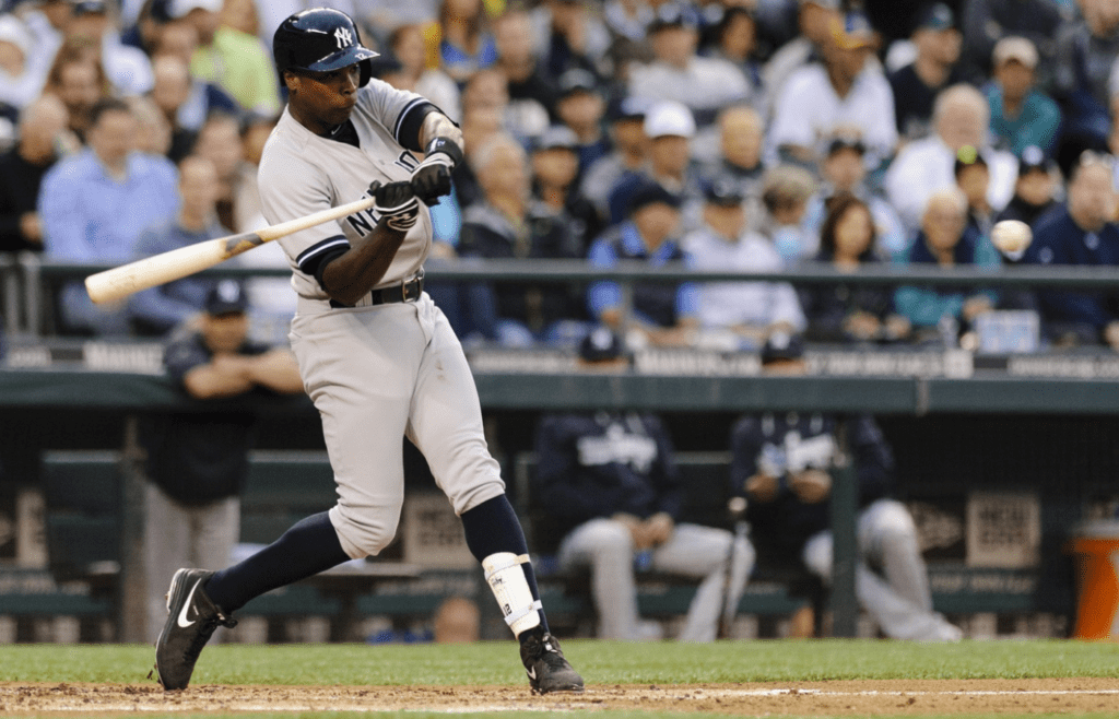 Jun 12, 2014; Seattle, WA, USA; New York Yankees right fielder Alfonso Soriano (12) hits a 2-RBI double against the Seattle Mariners during the third inning at Safeco Field. Mandatory Credit: Steven Bisig-Imagn Images