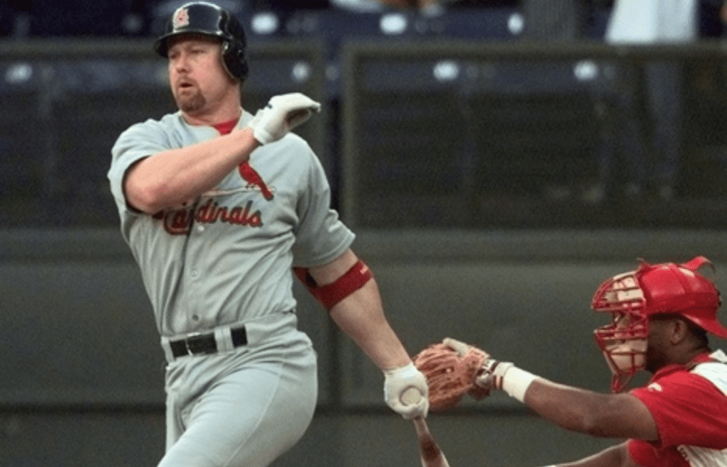 SEPTEMBER 10, 1998: St. Louis' Mark McGwire swings and misses at a pitch by Reds pitcher Mike Remlinger in the third inning at Cinergy Field.