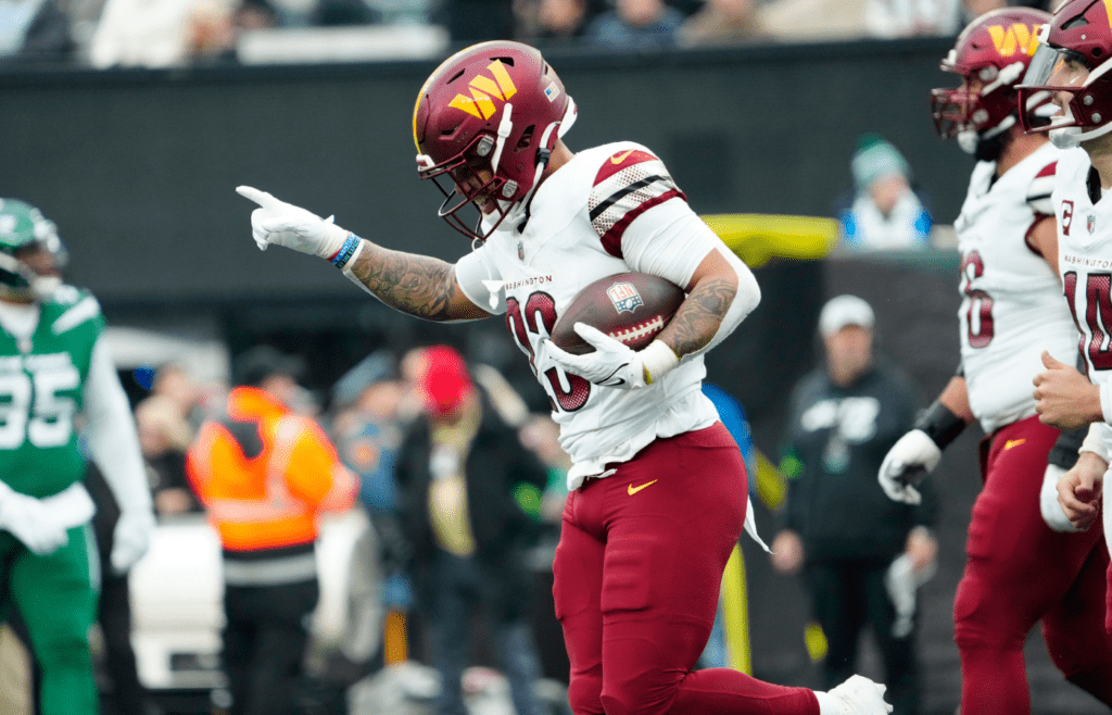 Washington Commanders running back Chris Rodriguez Jr. (23), celebrates seconds after scoring the only touchdown for his team in the first half, Sunday December 24, 2023.