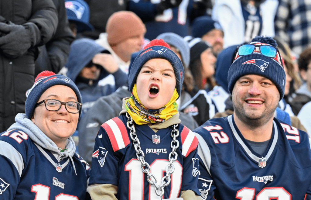 Dec 1, 2024; Foxborough, Massachusetts, USA; A young New England Patriots fan cheers for the team during the first half against the Indianapolis Colts at Gillette Stadium. Mandatory Credit: Eric Canha-Imagn Images
