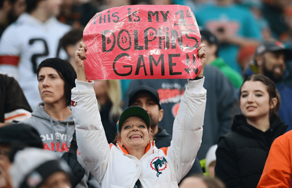 Dec 29, 2024; Cleveland, Ohio, USA; A Miami Dolphins fan holds a sign during the first half against the Cleveland Browns at Huntington Bank Field. Mandatory Credit: Ken Blaze-Imagn Images