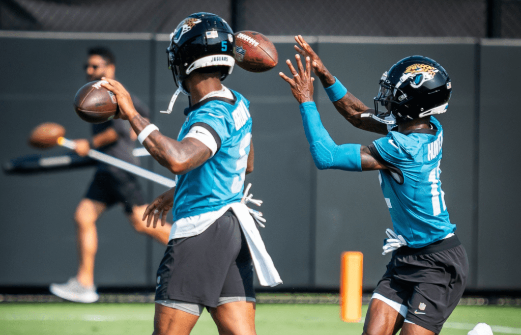 Jacksonville Jaguars wide receiver Travis Hunter (12) heals in a pass while running routes during the seventh organized team activity at the Miller Electric Center in Jacksonville, Fla. Monday, June 2, 2025. [Doug Engle/Florida Times-Union]