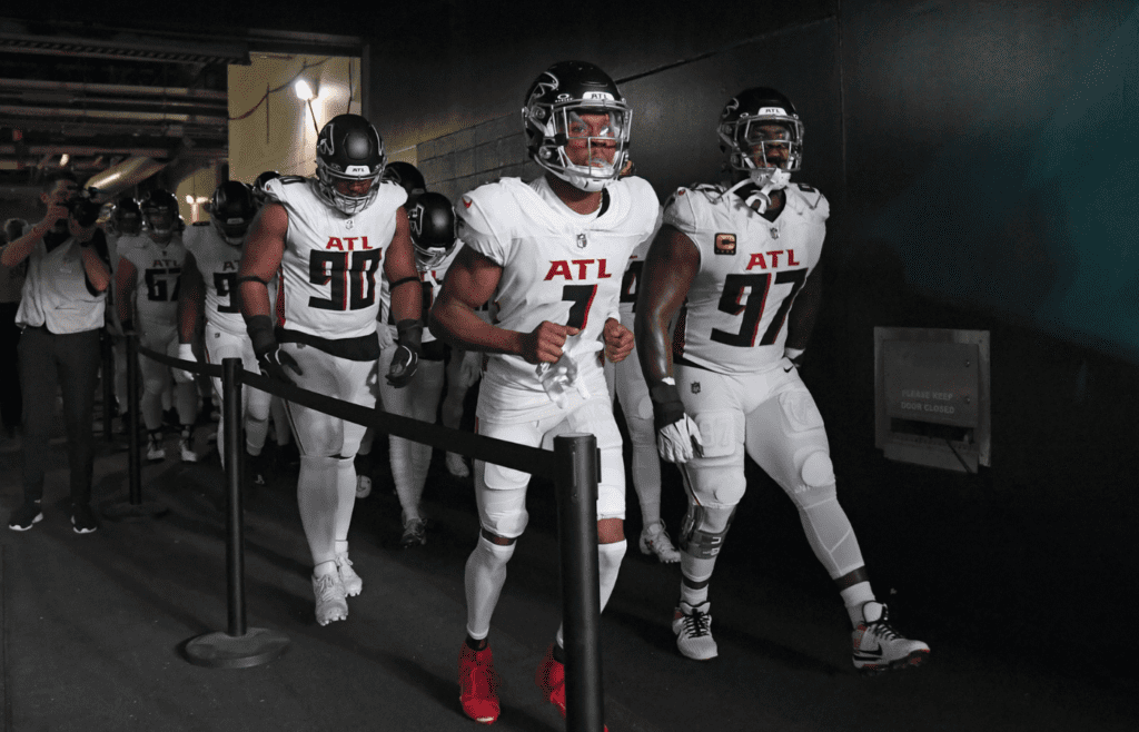 Sep 16, 2024; Philadelphia, Pennsylvania, USA; Atlanta Falcons defensive tackle David Onyemata (90), wide receiver Darnell Mooney (1) and defensive end Grady Jarrett (97) lead the team onto the field against the Philadelphia Eagles at Lincoln Financial Field. Mandatory Credit: Eric Hartline-Imagn Images