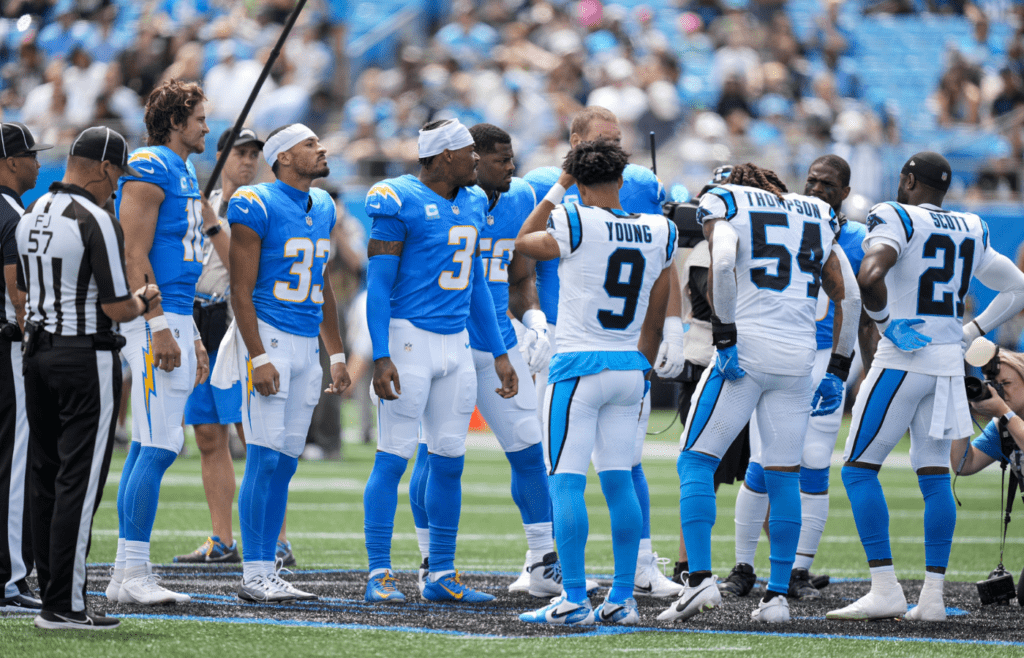 Sep 15, 2024; Charlotte, North Carolina, USA; Team captains meet for the coin toss during the first quarter between the Carolina Panthers and the Los Angeles Chargers at Bank of America Stadium. Mandatory Credit: Jim Dedmon-Imagn Images