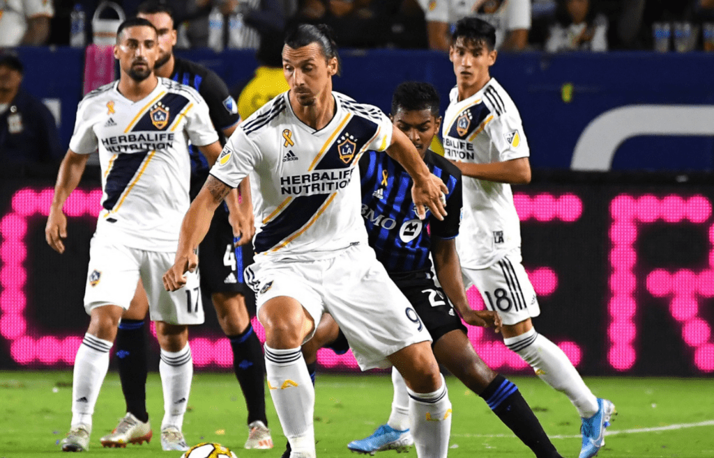 Sep 21, 2019; Carson, CA, USA; Los Angeles Galaxy forward Zlatan Ibrahimovic (9) controls the ball against Montreal Impact midfielder Shamit Shome (28) in the first half at StubHub Center. Mandatory Credit: Jayne Kamin-Oncea-Imagn Images