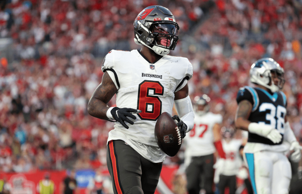 Jan 9, 2022; Tampa, Florida, USA; Tampa Bay Buccaneers running back Le'Veon Bell (6) runs the ball in for a touchdown against the Carolina Panthers during the first half at Raymond James Stadium. Mandatory Credit: Kim Klement-Imagn Images