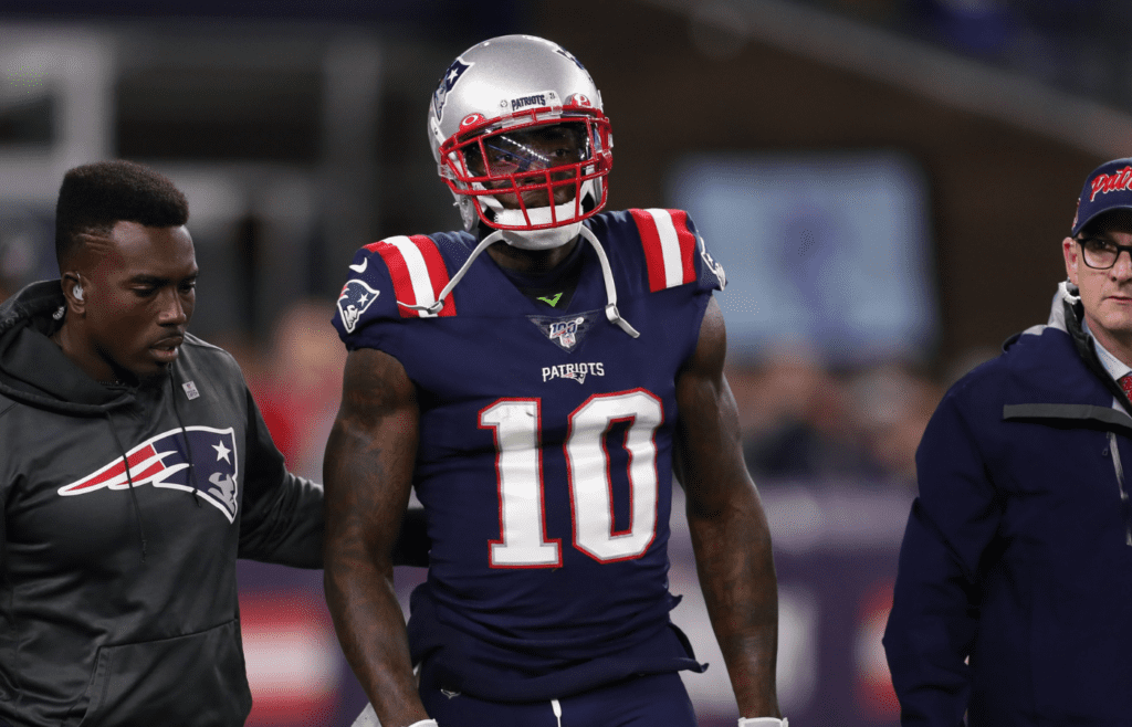 Oct 10, 2019; Foxborough, MA, USA; New England Patriots wide receiver Josh Gordon (10) is helped off of the field during the first half against the New York Giants at Gillette Stadium. Mandatory Credit: Paul Rutherford-Imagn Images