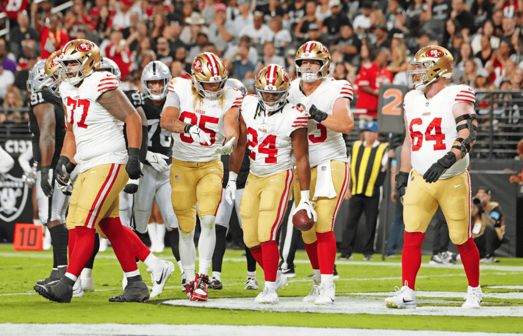 Aug 23, 2024; Paradise, Nevada, USA; San Francisco 49ers running back Jordan Mason (24) celebrates with team mates after scoring a touchdown against the Las Vegas Raiders during the first quarter at Allegiant Stadium. Mandatory Credit: Stephen R. Sylvanie-Imagn Images