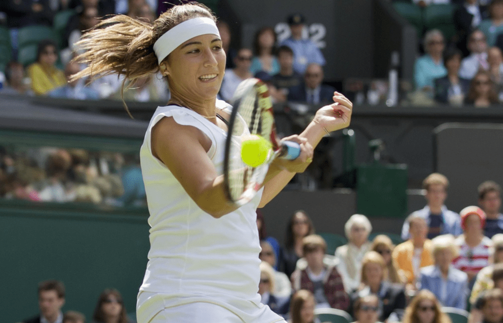 June 21, 2011; London, UNITED KINGDOM; Aravane Rezai (FRA) returns a shot against Serena Williams (USA) on day two of the 2011 Wimbledon Championships at the All England Lawn Tennis Club. Mandatory Credit: Susan Mullane-Imagn Images