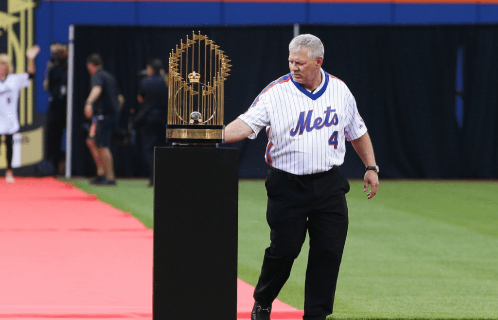 May 28, 2016; New York City, NY, USA; New York Mets former outfielder Lenny Dykstra touches the Commissioner's Trophy during a pregame ceremony honoring the 1986 World Series Championship team prior to the game against the Los Angeles Dodgers at Citi Field. Mandatory Credit: Andy Marlin-Imagn Images