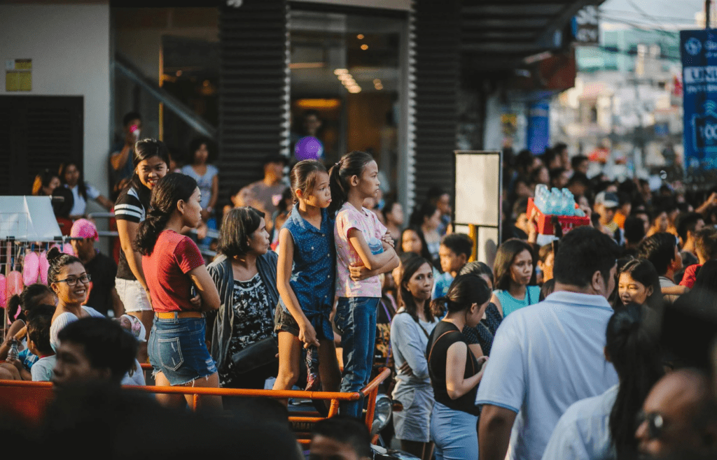 A crowded checkout line with people standing close together