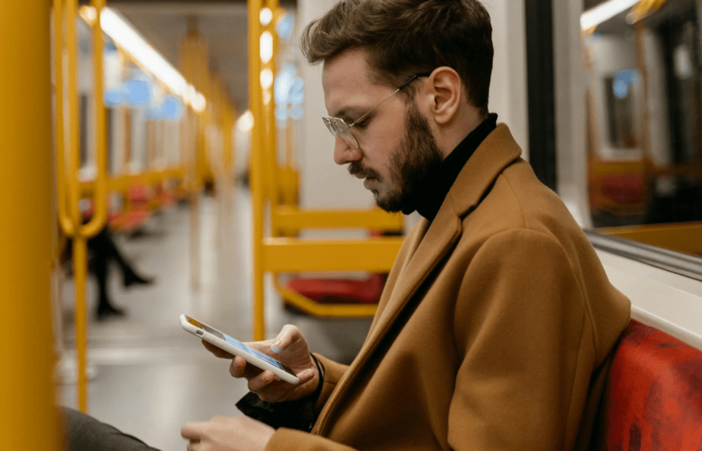 Someone on a train or bus watching a phone loudly