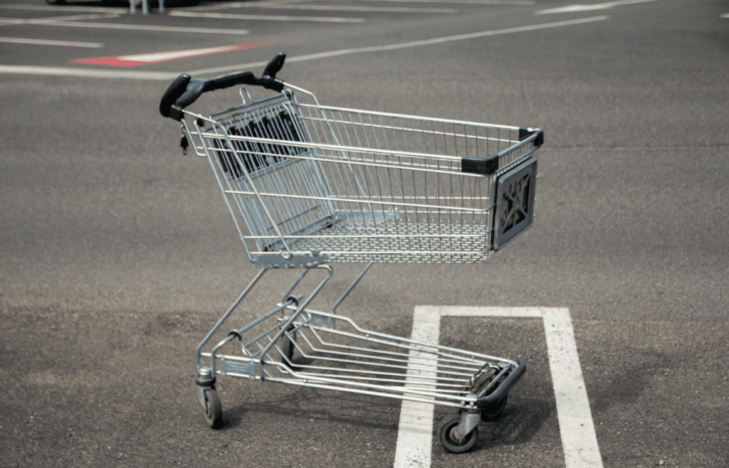 A shopping cart left in the middle of an empty parking spot