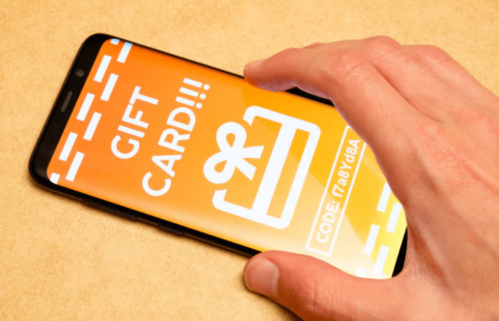 A digital gift card code on a screen
