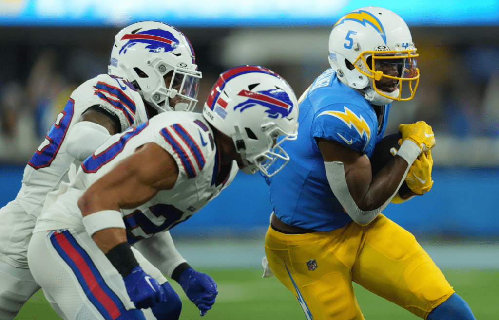 Dec 23, 2023; Inglewood, California, USA; Los Angeles Chargers wide receiver Joshua Palmer (5) is tackled by Buffalo Bills cornerback Cam Lewis (39) and safety Taylor Rapp (20) in the first half at SoFi Stadium. Mandatory Credit: Kirby Lee-Imagn Images