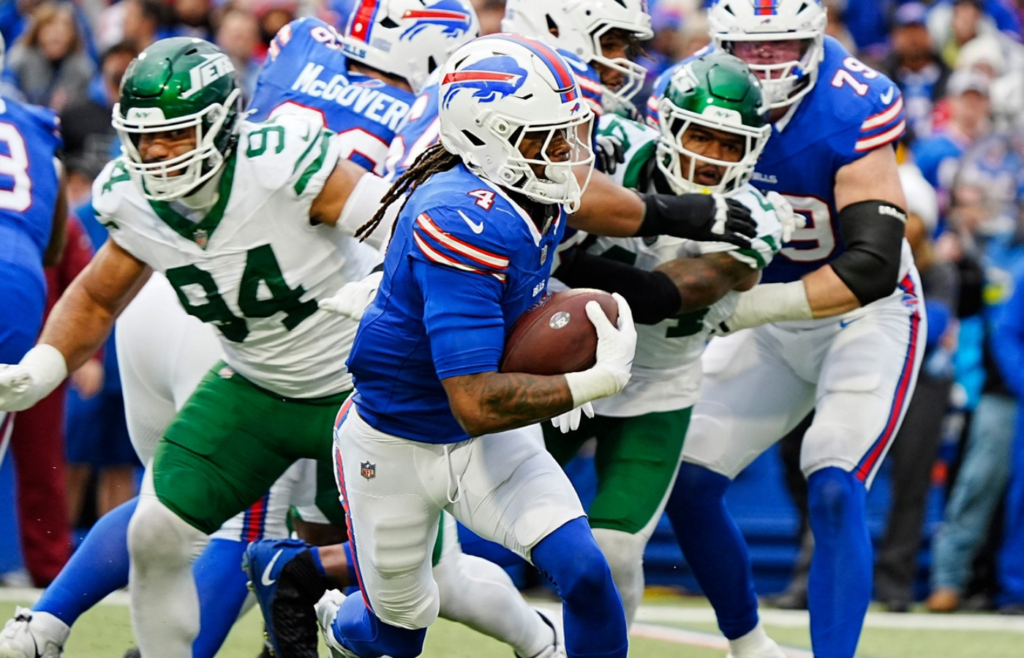 Buffalo Bills running back James Cook (4) finds an opening and runs with the ball for a gain of about six yards during first half action at the Bills home game against the New York Jets at Highmark Stadium in Orchard Park on Dec. 29, 2024.