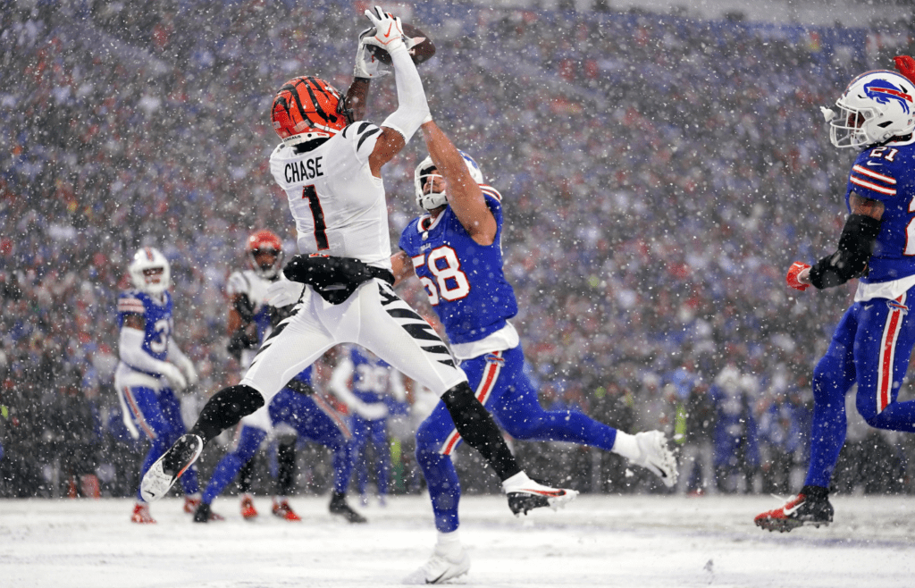 Cincinnati Bengals wide receiver Ja'Marr Chase (1) leaps fo a catch in the zone as Buffalo Bills linebacker Matt Milano (58) defends in the second quarter during an NFL divisional playoff football game between the Cincinnati Bengals and the Buffalo Bills, Sunday, Jan. 22, 2023, at Highmark Stadium in Orchard Park, N.Y. The catch was ruled incomplete upon further review.