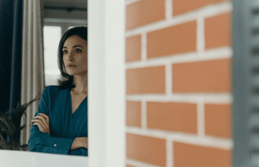 A person daydreaming while looking out a window