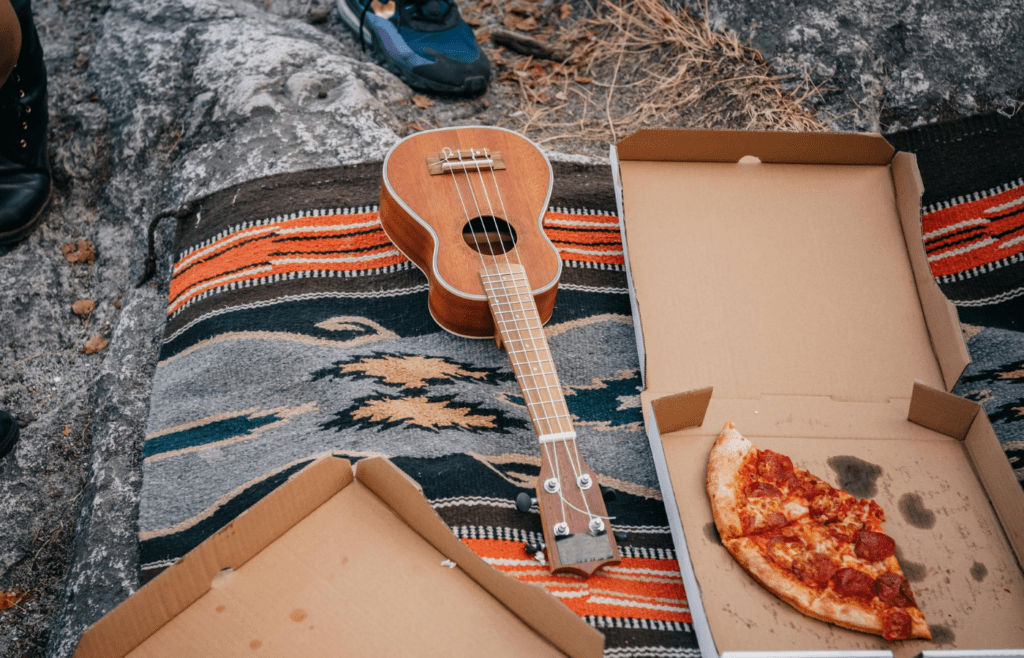 Leftover pizza in an open cardboard pizza box