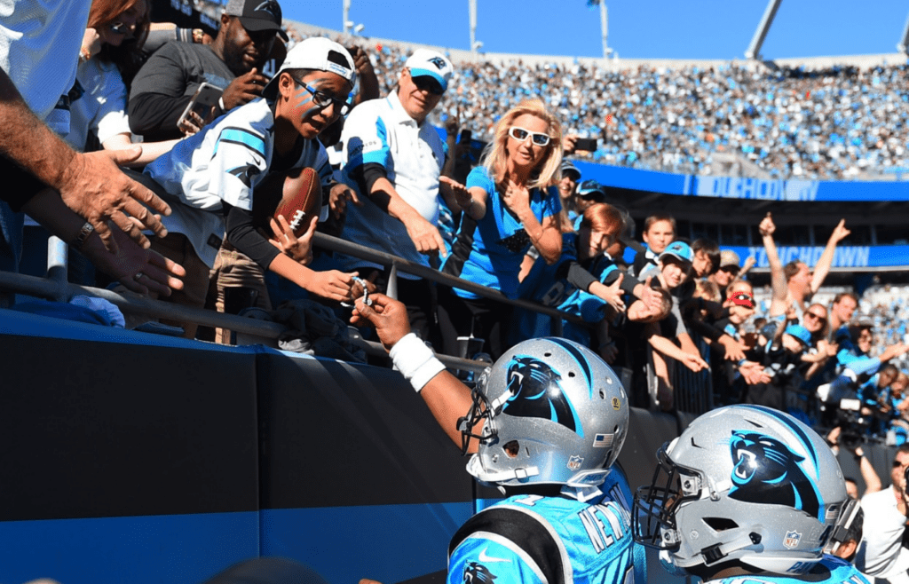 Oct 28, 2018; Charlotte, NC, USA; Carolina Panthers quarterback Cam Newton (1) hands the football to a fan after scoring a touchdown in the fourth quarter at Bank of America Stadium. Mandatory Credit: Bob Donnan-Imagn Images