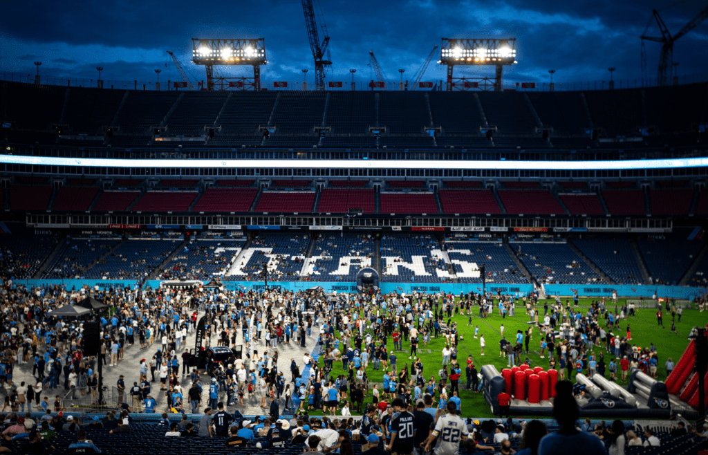 Fans gather on the field during the Tennessee Titans NFL Draft Watch Party at Nissan Stadium in Nashville, Tenn., Thursday, April 24, 2025