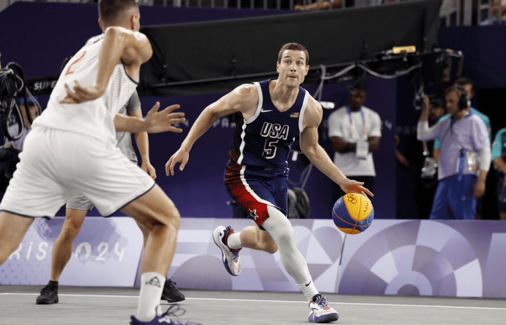 Jul 30, 2024; Paris, France; United States player Jimmer Fredette (5) controls the ball against Serbia in the men’s pool basketball 3x3 game during the Paris 2024 Olympic Summer Games at La Concorde 1. Mandatory Credit: Yukihito Taguchi-Imagn Images