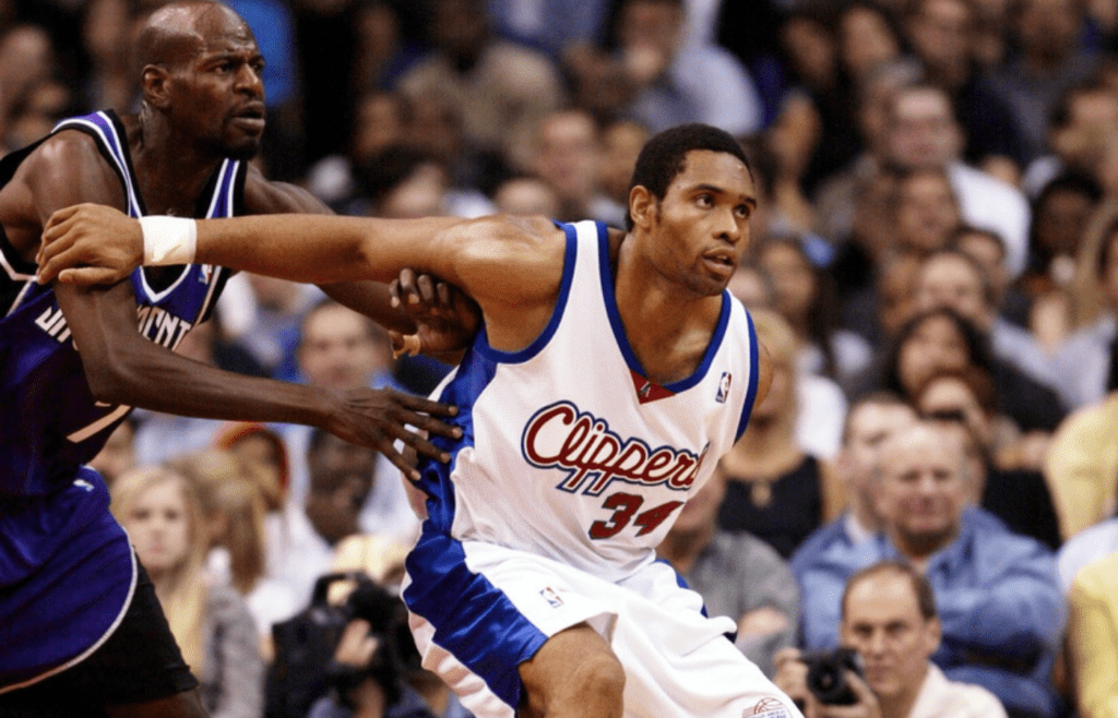 Nov 20, 2002; Los Angeles, CA, USA; FILE PHOTO; Los Angeles Clippers player Michael Olowokandi works the baseline on the Sacramento Kings player Keon Clark during the 1st half at Staples Center. Mandatory Credit: Robert Hanashiro-Imagn Images