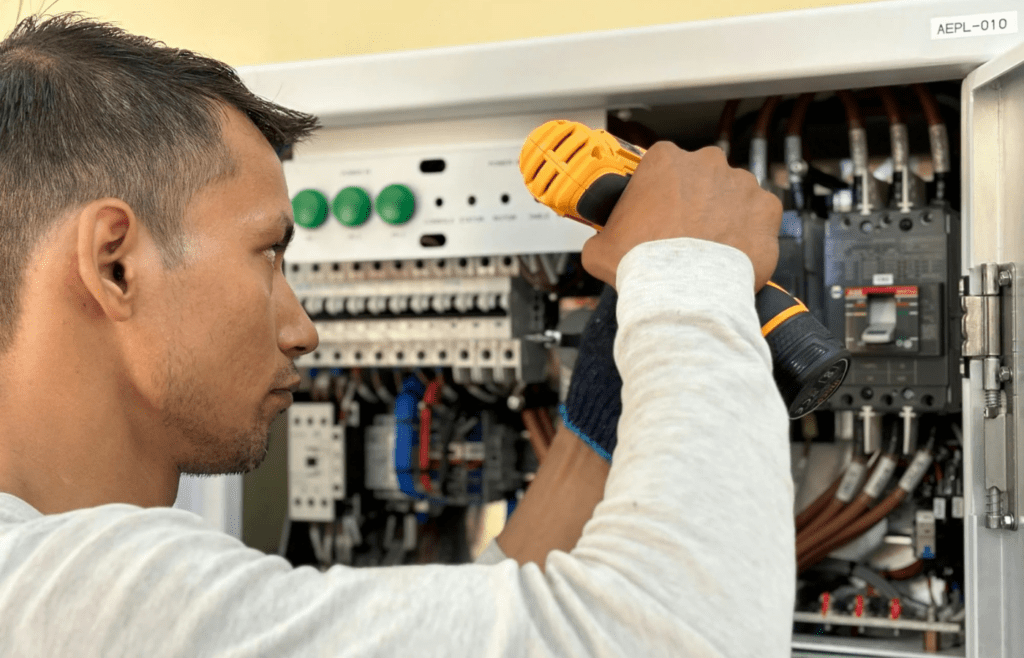An electrician installing wiring in a residential setting