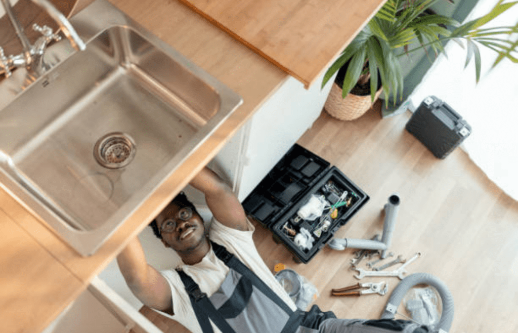 A plumber fixing a kitchen sink.