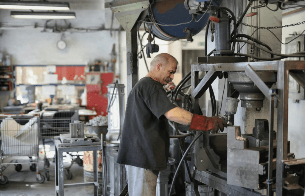 A mechanic repairing industrial equipment in a factory