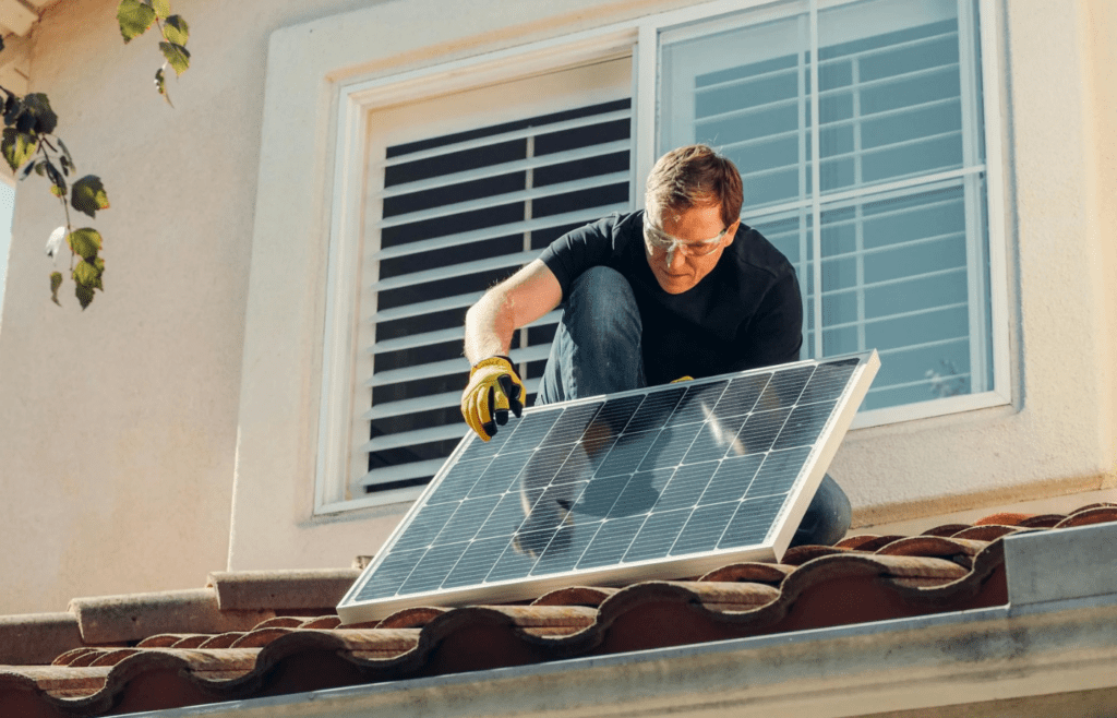 A technician installing solar panels on a rooftop