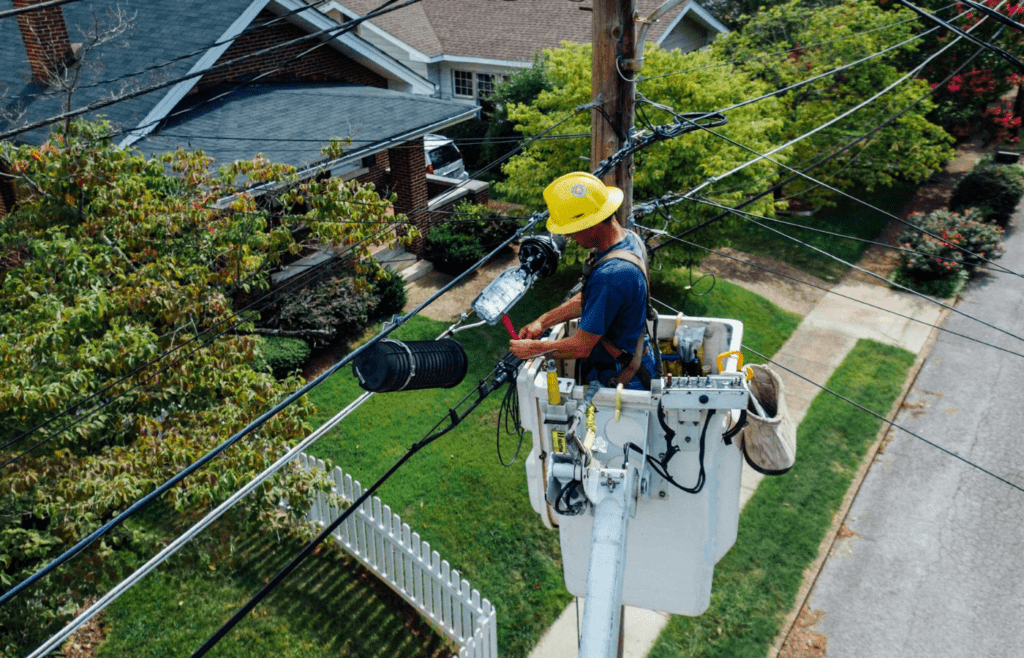 A worker repairing overhead power lines