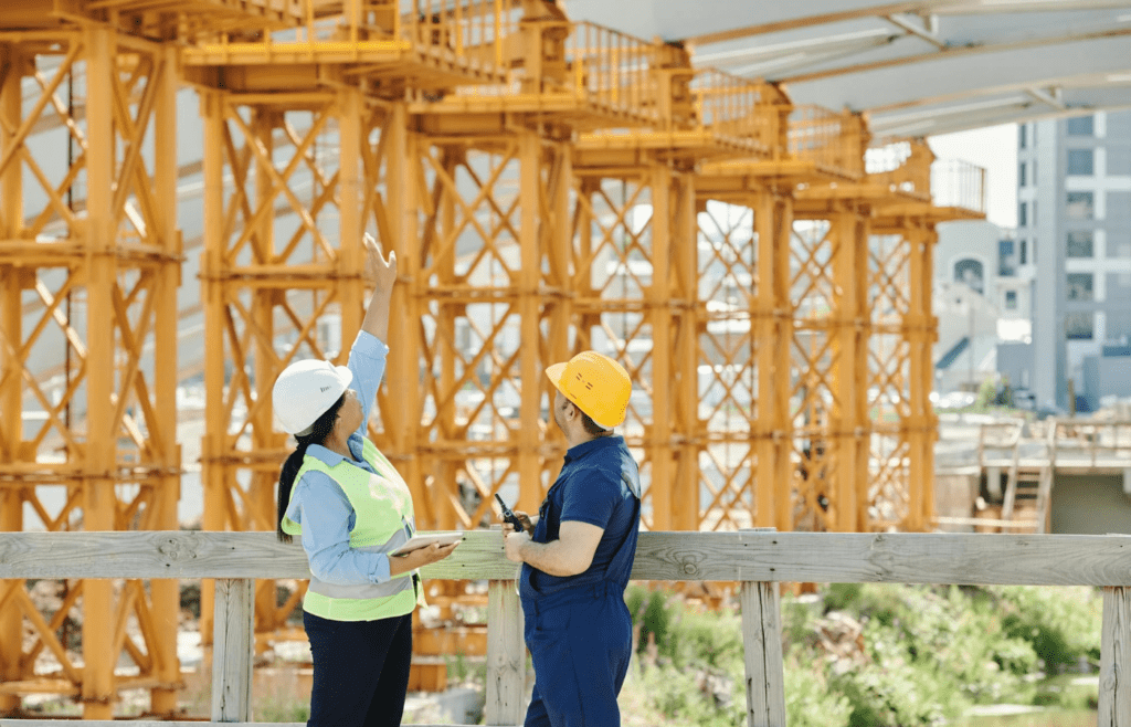 A construction manager reviewing blueprints on-site