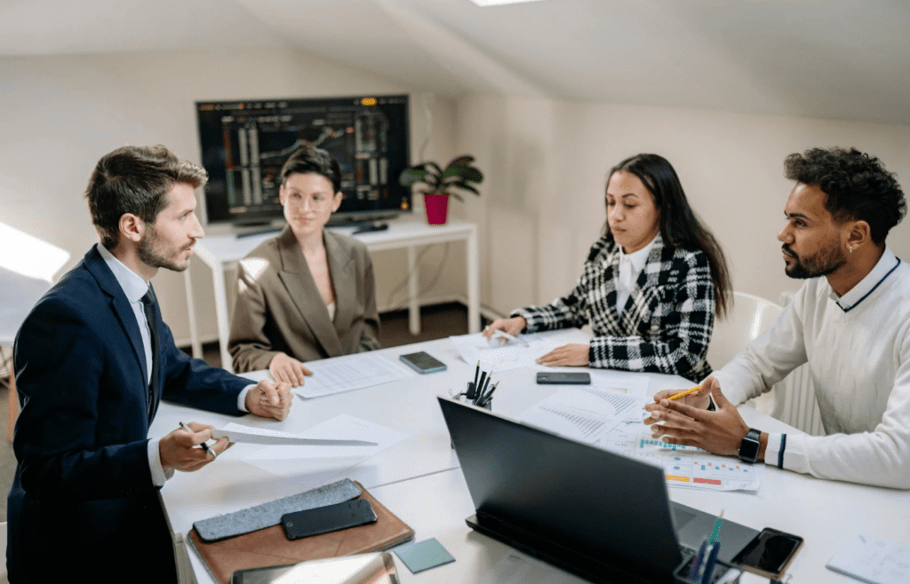 A team meeting with one person looking pressured