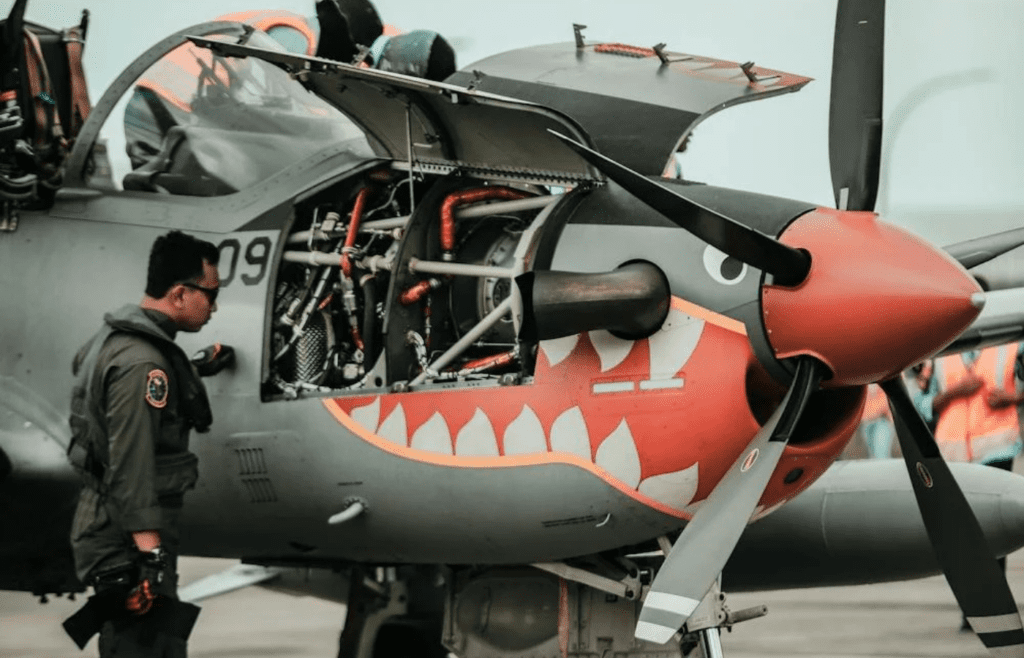 A mechanic inspecting an airplane engine