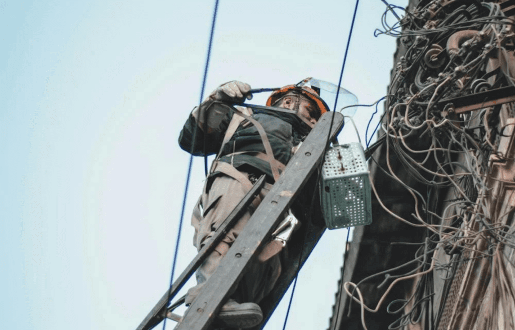 An electrician installing wiring in a building