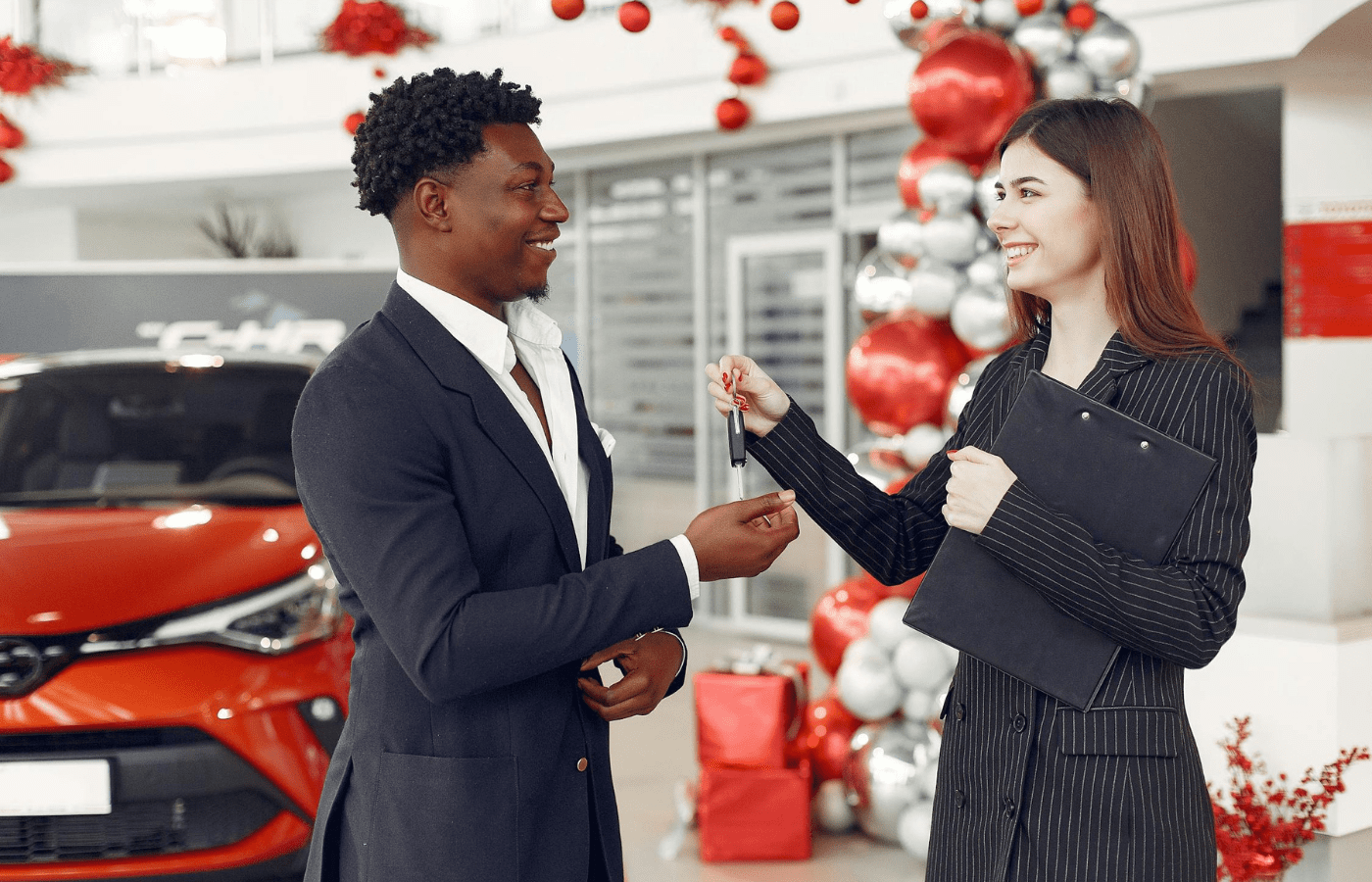 A dealership handing over keys to a leased car