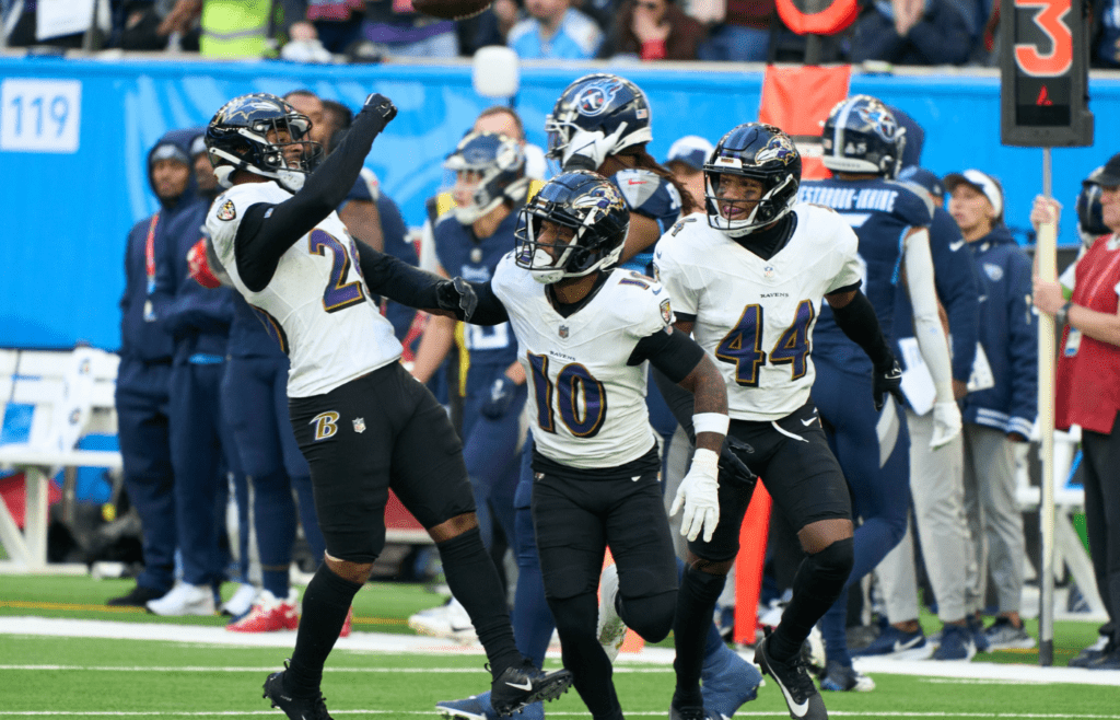 Oct 15, 2023; London, United Kingdom; Baltimore Ravens safety Geno Stone (26) celebrates with team mates as he carries the ball during the second half of an NFL International Series game at Tottenham Hotspur Stadium. Mandatory Credit: Peter van den Berg-Imagn Images