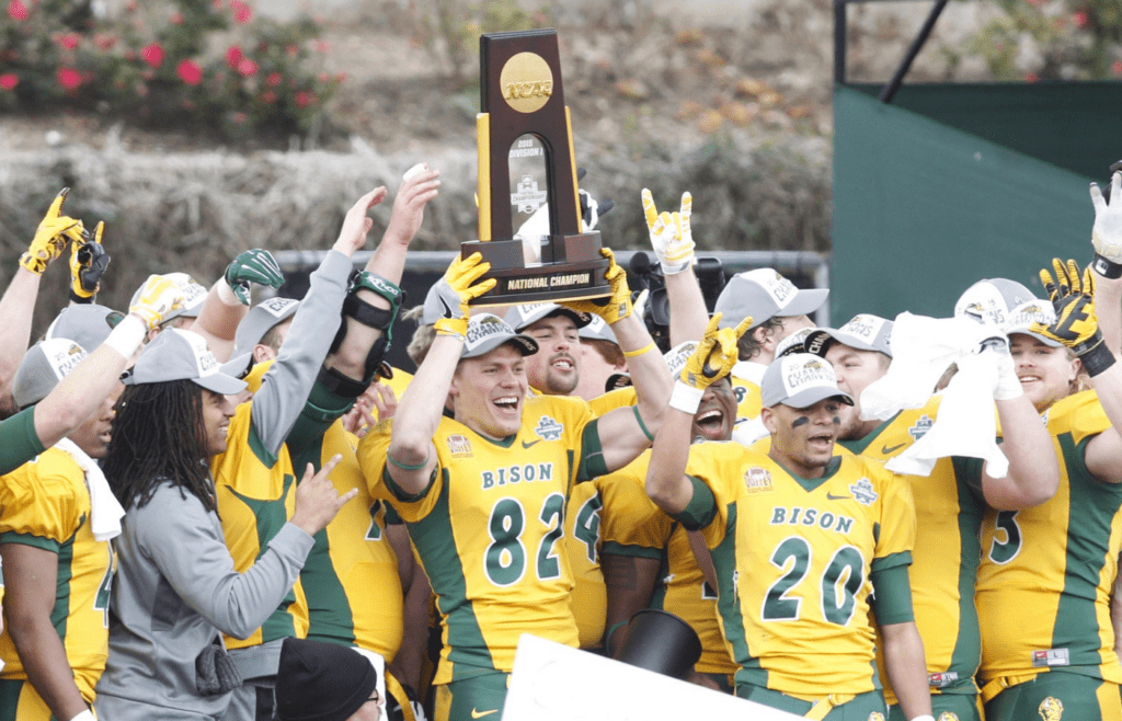 Jan 9, 2016; Frisco, TX, USA; North Dakota State Bison players hold up the championship trophy after the game against the Jacksonville State Gamecocks in the FCS Championship college football game at Toyota Stadium. North Dakota State won the championship 37-10. Mandatory Credit: Tim Heitman-Imagn Images