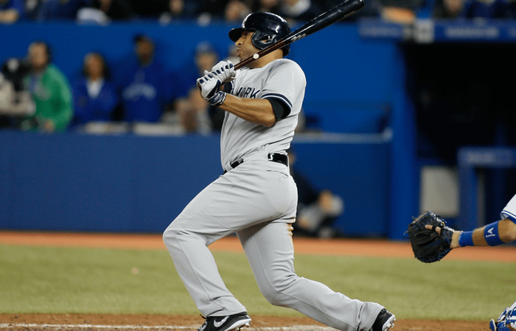 Sep 18, 2013; Toronto, Ontario, CAN; New York Yankees right fielder Vernon Wells (22) hits a two run double in the eighth inning against the Toronto Blue Jays at the Rogers Centre. New York defeated Toronto 4-3. Mandatory Credit: John E. Sokolowski-Imagn Images