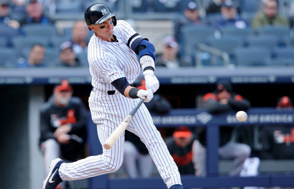 Mar 28, 2019; Bronx, NY, USA; New York Yankees shortstop Troy Tulowitzki (12) hits a double against the Baltimore Orioles during the eighth inning at Yankee Stadium. Mandatory Credit: Brad Penner-Imagn Images