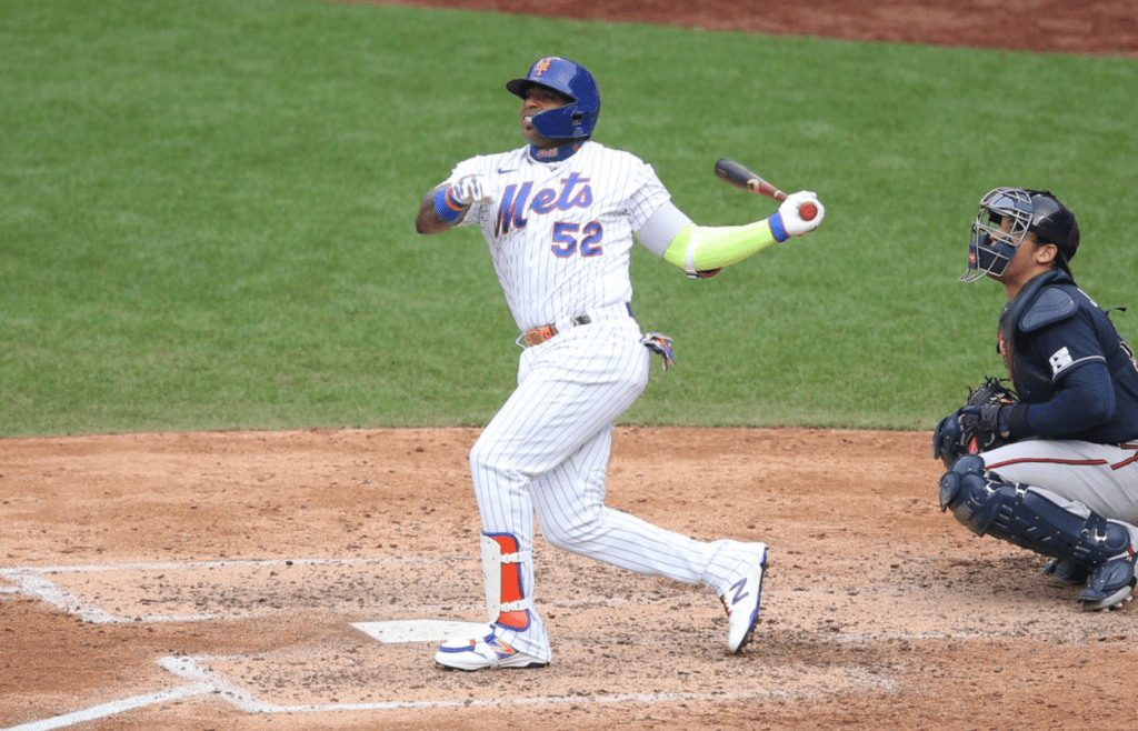 Jul 24, 2020; New York City, New York, USA; New York Mets outfielder Yoenis Cespedes (52) follows through on a solo home run against the Atlanta Braves during the seventh inning of an opening day game at Citi Field. Mandatory Credit: Brad Penner-Imagn Images