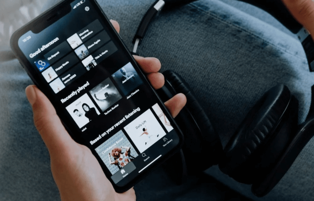 A smartphone showing a paused playlist