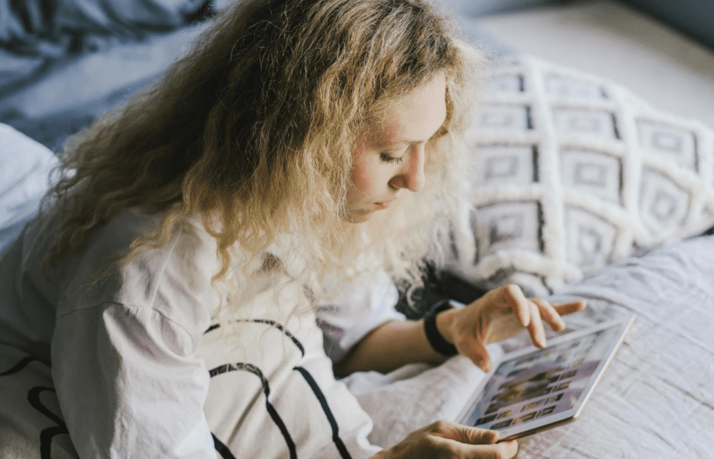 A person scrolling news headlines on a tablet