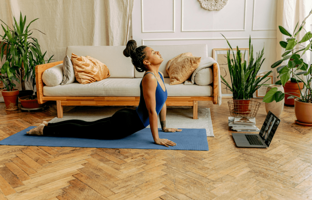 A laptop set up for an online yoga session