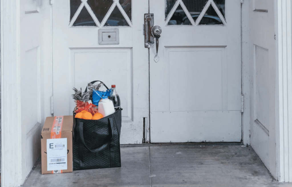 Grocery bags delivered to a front porch