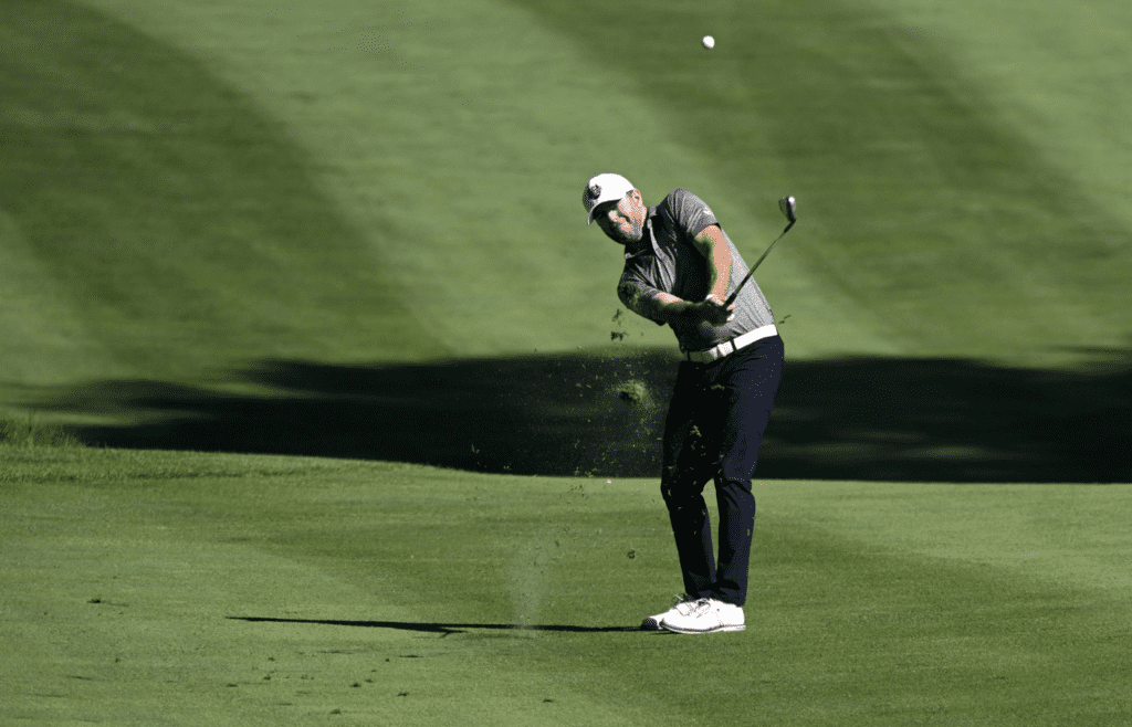 Jun 30, 2022; Silvis, Illinois, USA; Robert Garrigus of Banks Oregon hits his approach shot on the ninth hole during the first round of the John Deere Classic golf tournament. Mandatory Credit: Marc Lebryk-Imagn Images