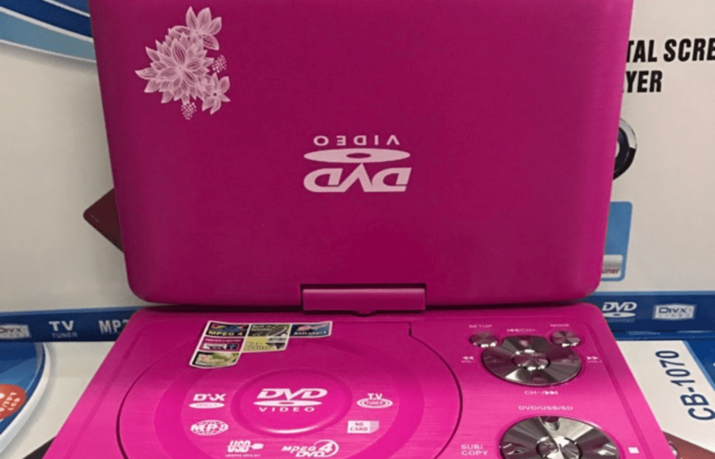 An HD DVD player with red cases stacked beside it