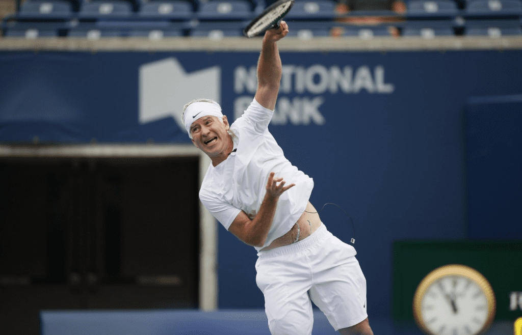 Aug 11, 2013; Toronto,ON, Canada; John McEnroe (USA) serves to Jim Courier (USA) (not pictured) during the Legends exhibition match at the Rexall Centre. Mandatory Credit: John E. Sokolowski-Imagn Images