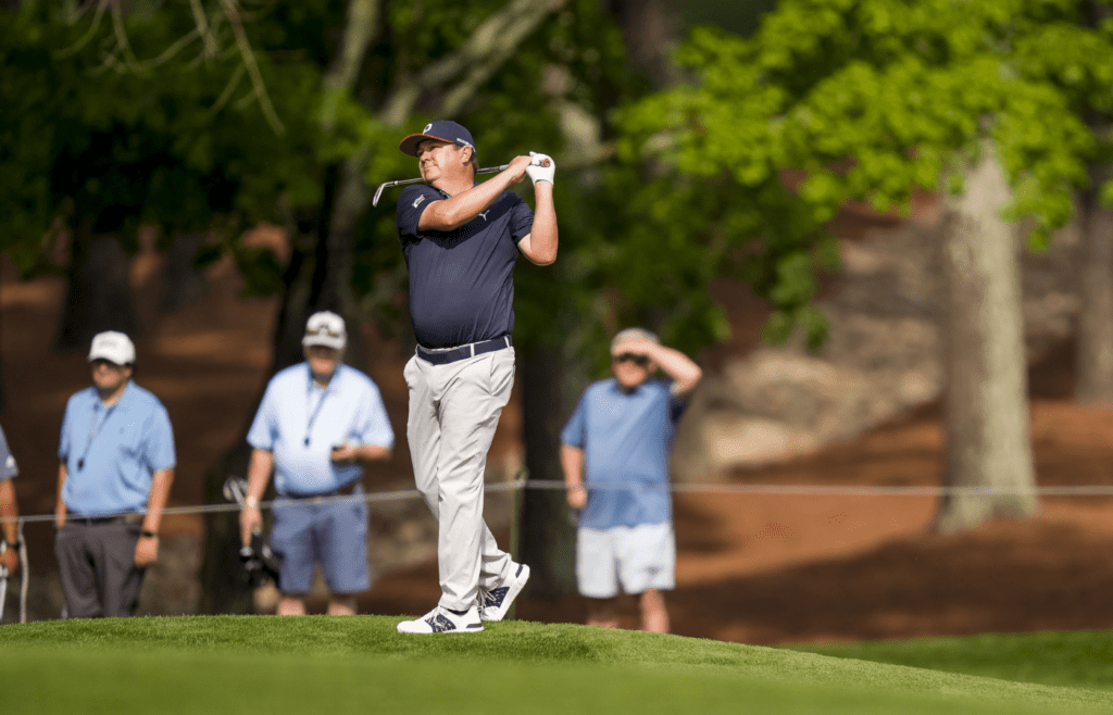 Jason Dufner hits his approach shot on the fifth hole green during the second round of the PGA Championship golf tournament at Quail Hollow